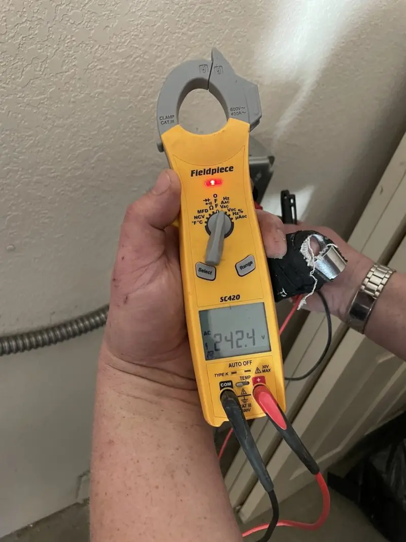 Voltage testing with clamp meter during Whole House Surge Protector in Ranson corporation